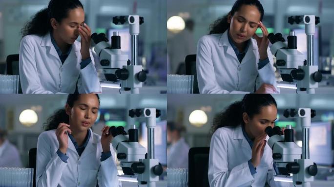 4k视频片段，一名年轻女子在实验室使用显微镜时头痛