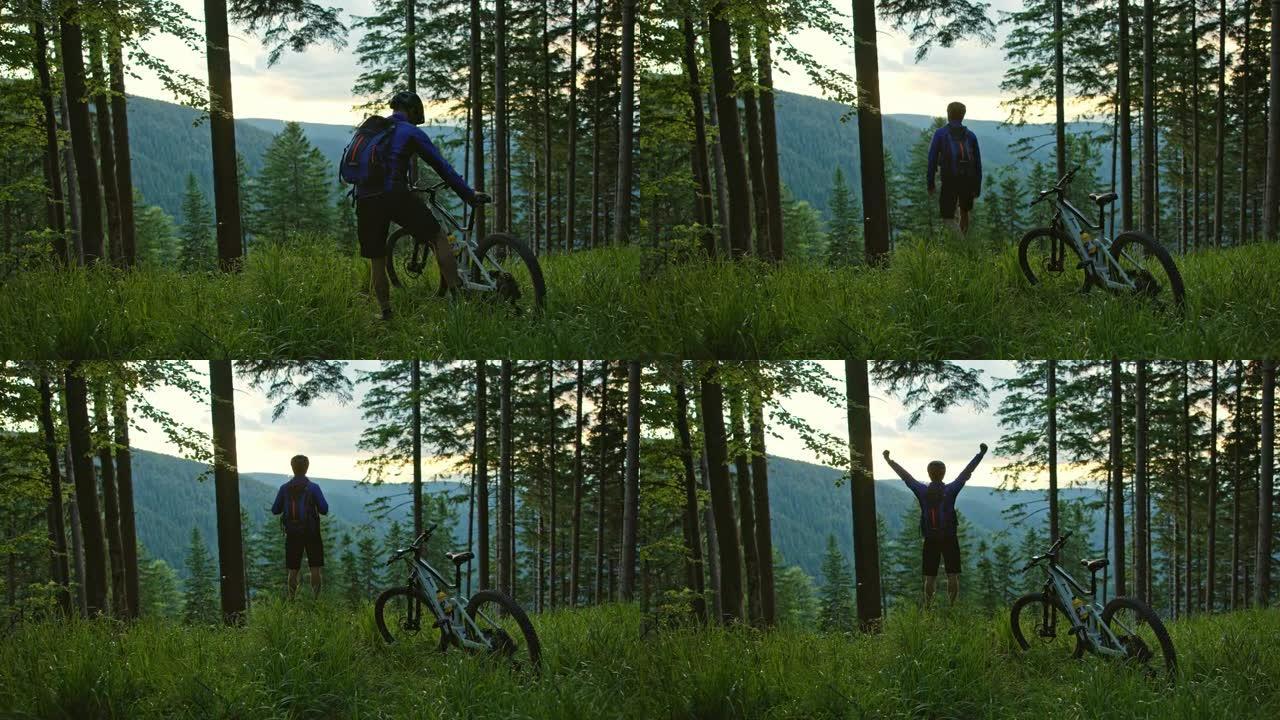 SLO MO Mountain骑自行车的人停下来从森林中的林间空地上欣赏山谷的美景