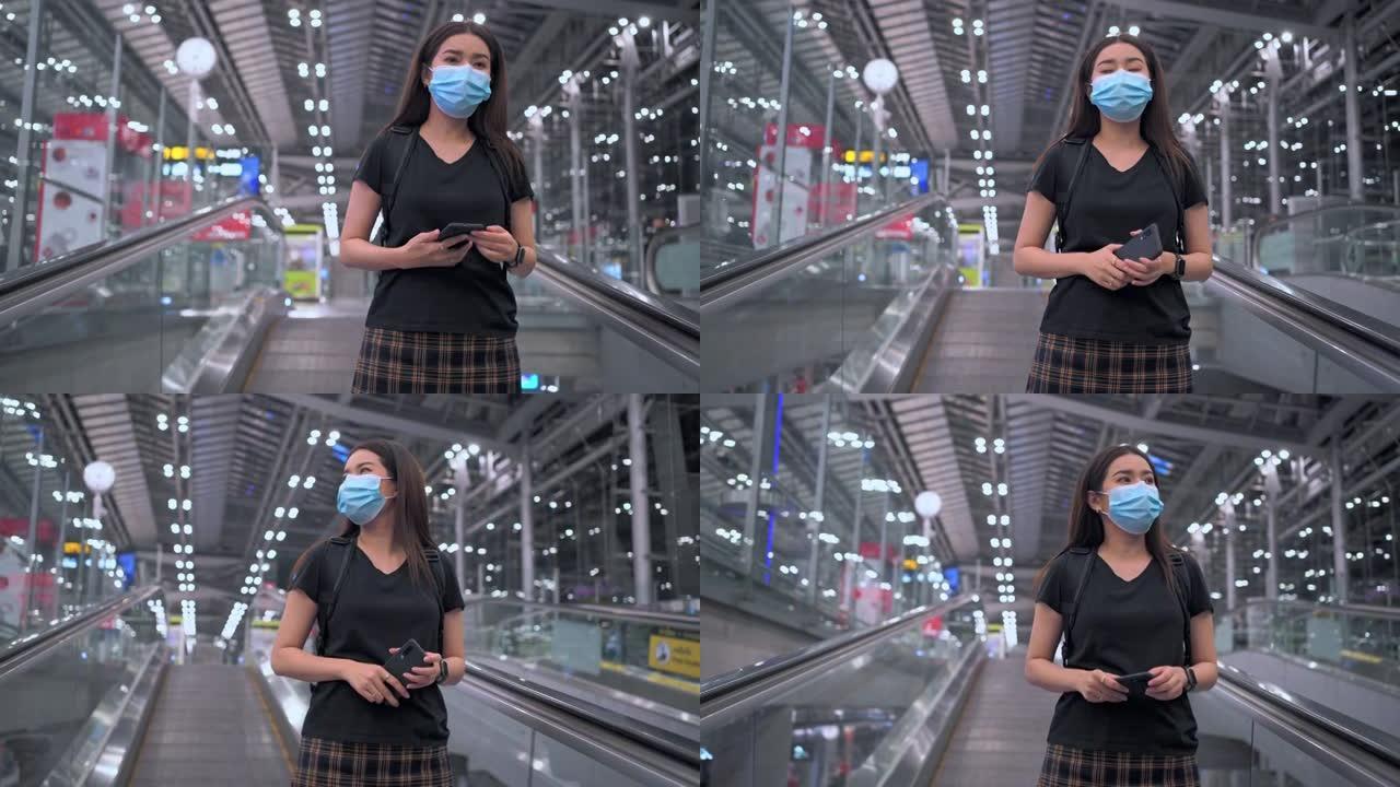 宽幅镜头: 亚洲妇女在等待在机场度假时正在看手机