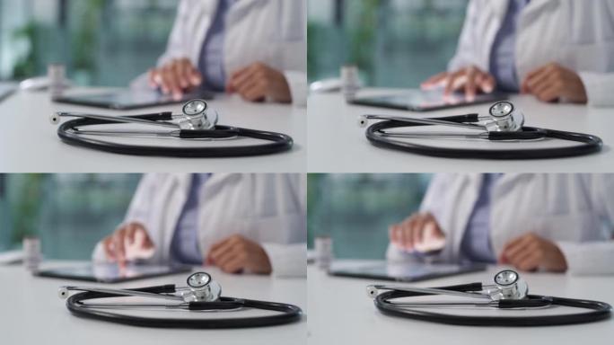 在现代医院中，医生在办公桌上使用数字平板电脑的4k视频片段