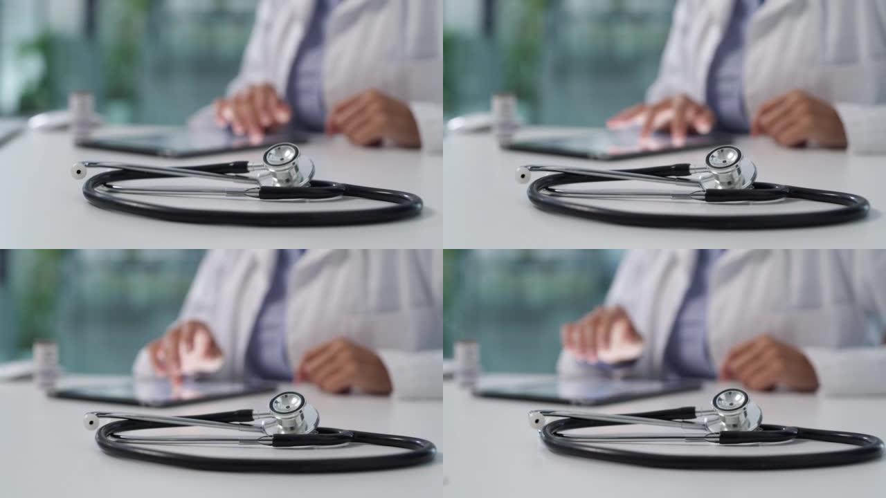 在现代医院中，医生在办公桌上使用数字平板电脑的4k视频片段