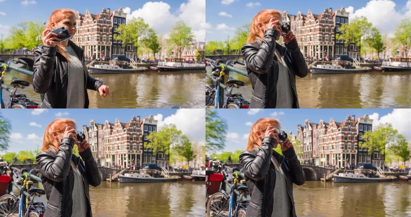 女人享受阳光明媚的日子，欣赏阿姆斯特丹的运河，用老式复古模拟相机拍照