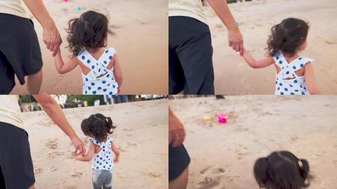 特写父亲与可爱的女儿在海滩度假时玩耍和散步