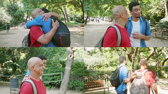 深情的父亲在公园里拥抱年轻的成年儿子