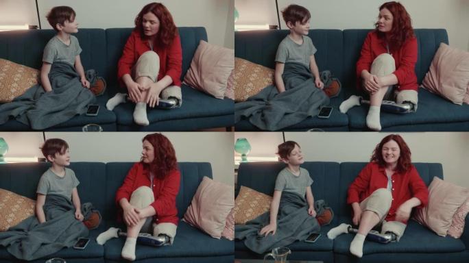 美丽快乐的残疾人35-40白人母亲与仿生假肢交谈十几岁的儿子坐在家里的沙发上