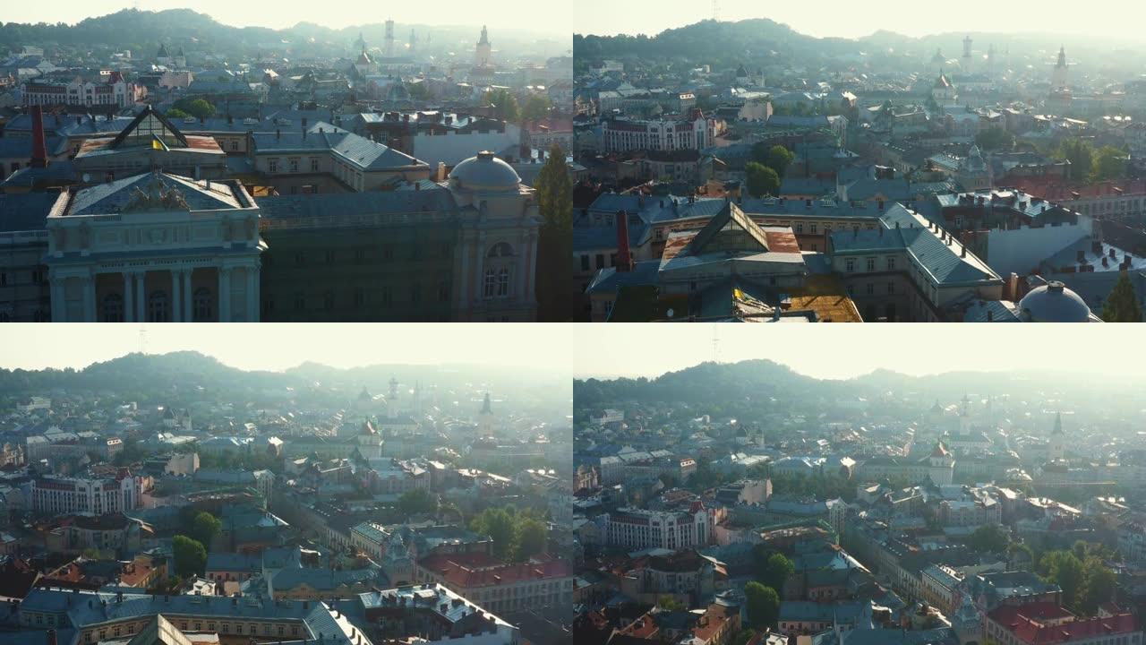无人机升起在利沃夫老城的历史建筑与乌克兰国旗，展示美丽的城市景观在夏季日出