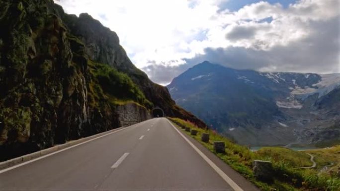 在美丽的晴天，在山口公路上行驶，穿过风景如画的充满活力的风景