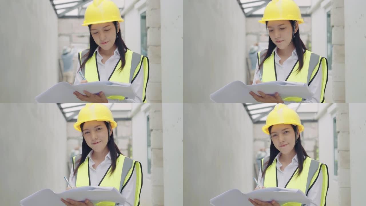 女建筑工程师在建筑工地上看蓝图的肖像