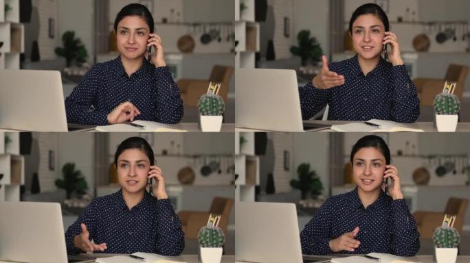 印度女商人拿着智能手机与客户远程通话