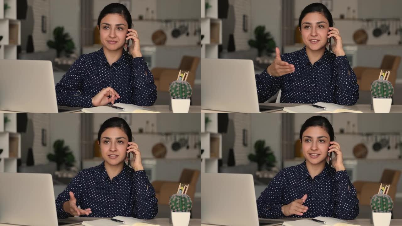 印度女商人拿着智能手机与客户远程通话