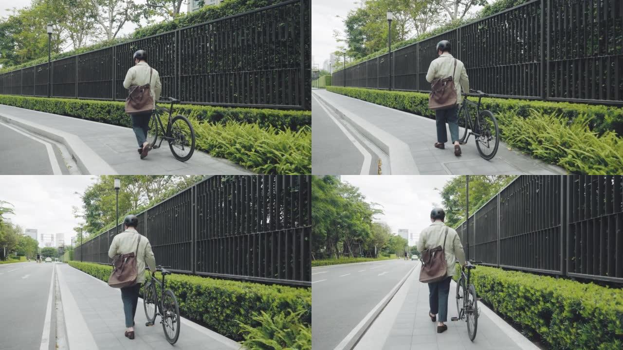 英俊的男人骑着自行车在街上上班