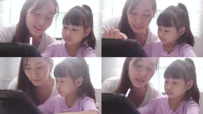 亚洲女儿与母亲在家学习在线课程