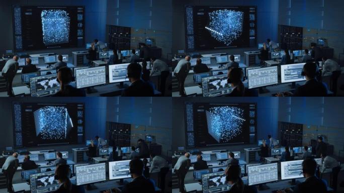 在现代监控办公室工作的工程师的静态镜头，在大屏幕上显示实时神经网络。监控室大数据科学家和管理人员坐在
