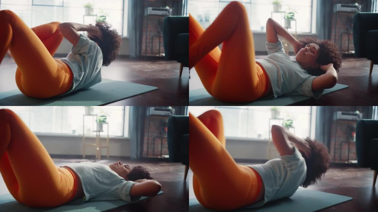 非裔美国妇女在家训练时做纵横交错的紧缩锻炼。黑人女性每天早上做腹部锻炼。运动概念