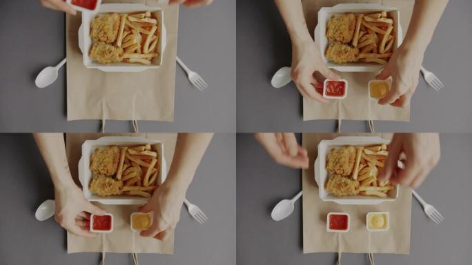创意平放美味的食物装在纸袋上的容器里，女性双手送餐