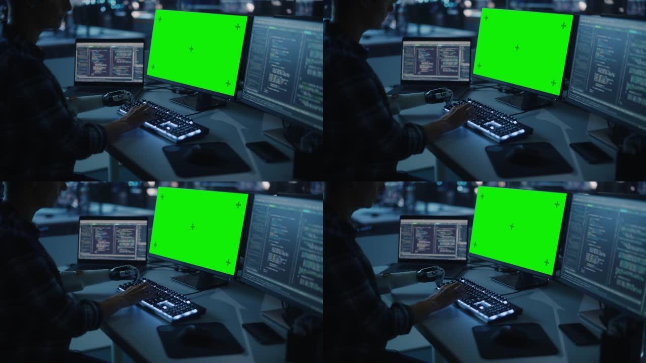 夜间办公室: 残疾人使用假肢在绿屏色度键计算机上工作。快速自然地使用肌电仿生手在夜间为软件键入代码。