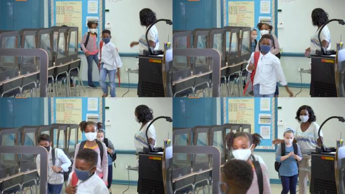 老师，学生在新型冠状病毒肺炎大流行期间在教室里