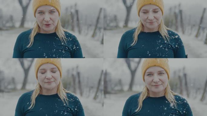 SLO MO肖像，一个女人在雪地里摆姿势时深呼吸