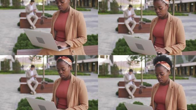 黑人女商人在户外使用笔记本电脑