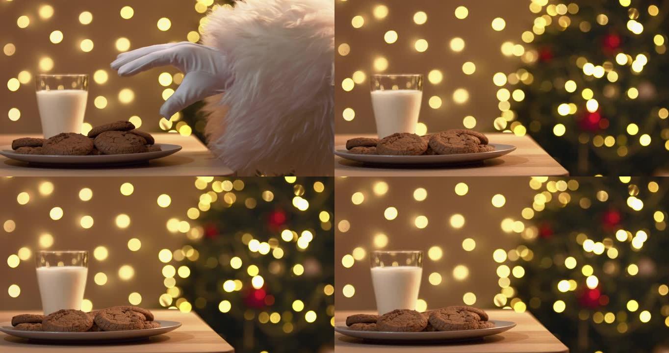 圣诞老人戴着白手套的手从盘子里偷饼干的特写镜头。圣诞幽默。