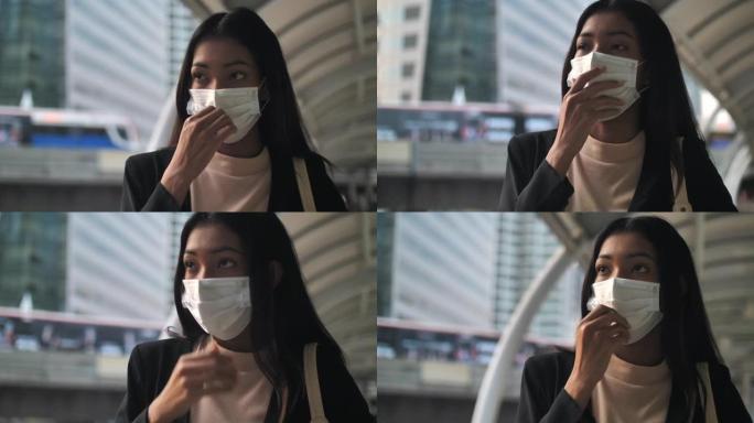 亚洲女商人戴上流感面具