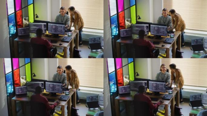 时尚的办公空间: 由开发人员组成的多元化团队在带有多个显示器的台式计算机上编写代码。女性初创公司创始