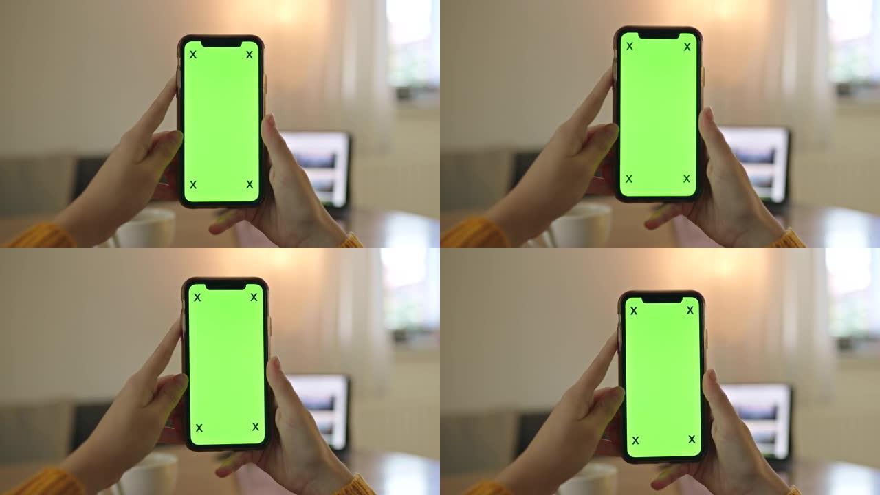 MS无法识别的人在家中拿着色度键绿屏智能手机