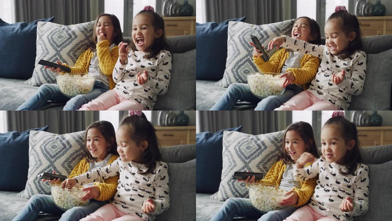 两个小女孩在家吃爆米花看电影时结为纽带的4k视频片段