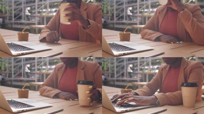 无法识别的女商人在咖啡馆的笔记本电脑上工作