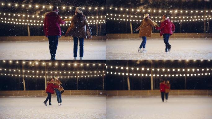 浪漫的冬天下雪的夜晚: 滑冰夫妇玩得开心，踏上溜冰场，开始跳舞。双人滑冰。年轻人拿着Halds。恋爱