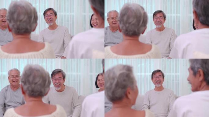 一群60-70岁的亚洲活跃老年人在疗养院交谈并度过了一段美好的时光。社会老年人