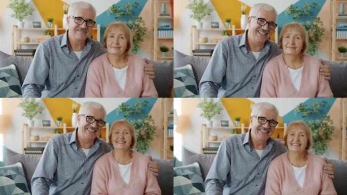 年迈的夫妻表情严肃地看着镜头，然后笑着笑