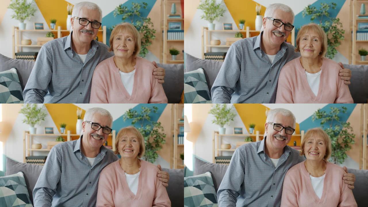 年迈的夫妻表情严肃地看着镜头，然后笑着笑