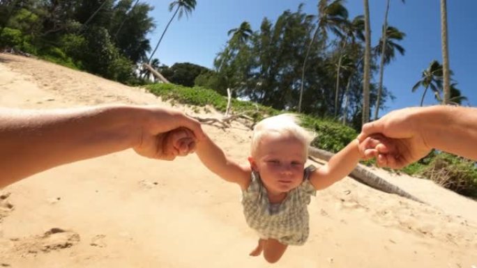 在阳光明媚的夏日，波夫父亲牵着手在热带海滩上旋转小女儿
