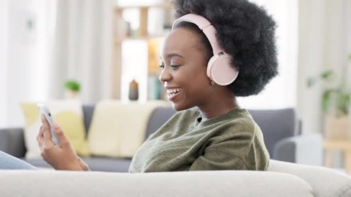 Cheerful african afro woman using phone and headph