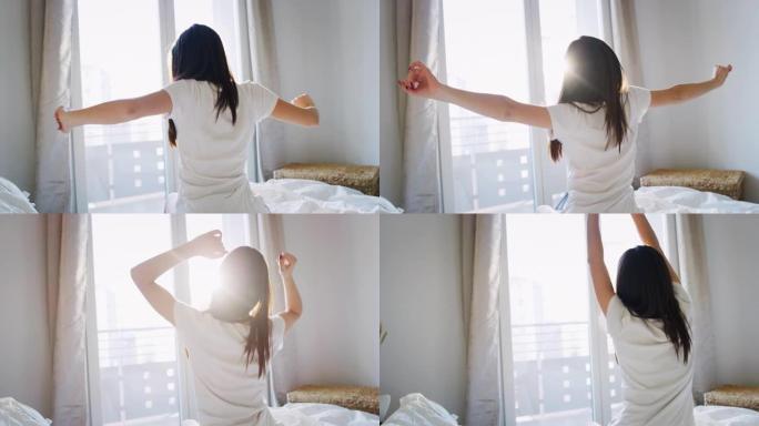 真实的近距离拍摄的一个年轻的黑发女子是醒来的床