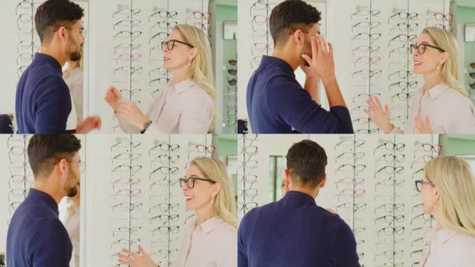 配镜师帮助客户在验光时选择眼镜。男性顾客咨询验光师配戴眼镜的眼镜，以提高视力并检查镜子