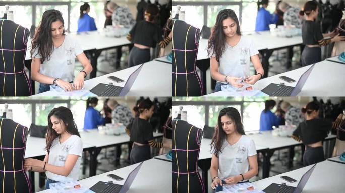 亚洲大学时装学生在教室里上课，与人体模特一起从事时装设计项目