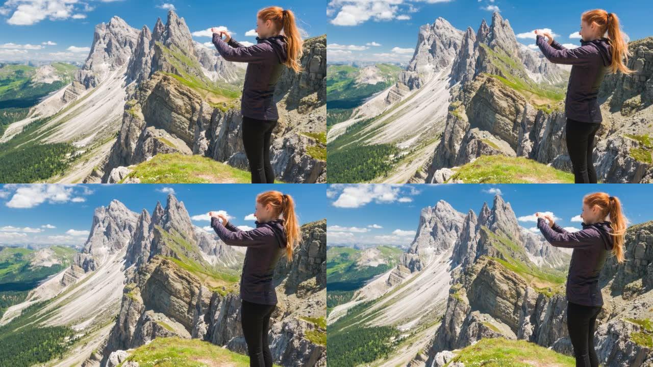 多洛米蒂山脉塞塞达山上的女旅行者拍摄令人叹为观止的景色