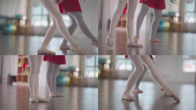 低段亚洲中国少女芭蕾舞演员tip脚在工作室训练她的年轻女学生