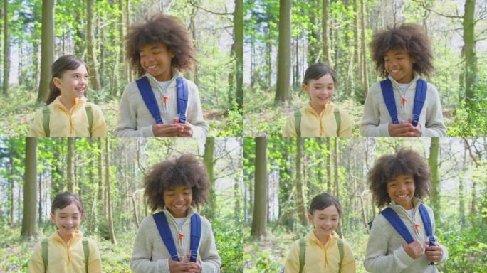 男孩和女孩穿过春季林地的风信子，朝着慢动作拍摄的镜头前视图
