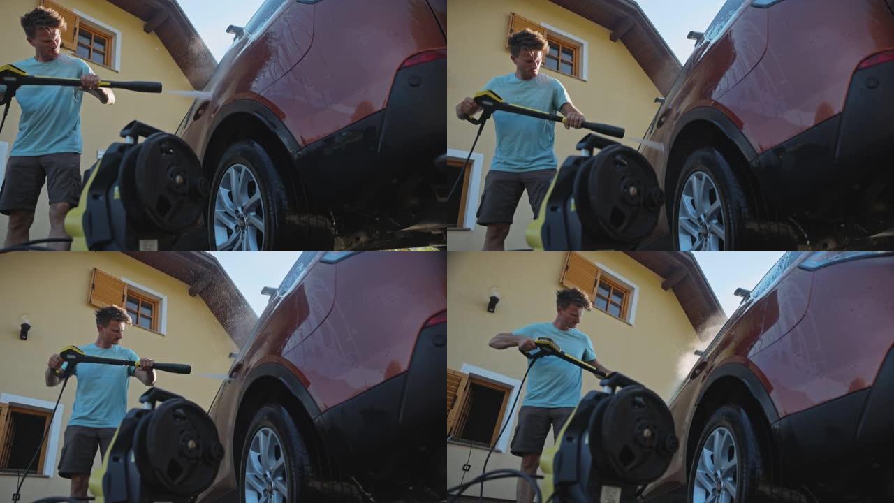 SLO MO Man使用压力清洗机在车道上洗车