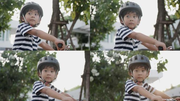 男孩骑自行车。小男孩骑车