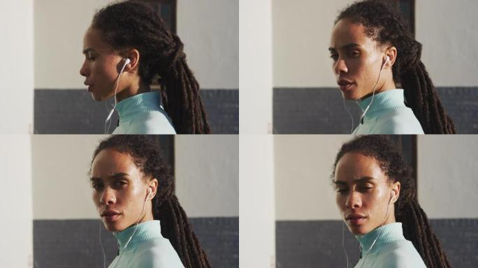 晴天穿着运动服的非裔美国妇女的肖像戴着耳机