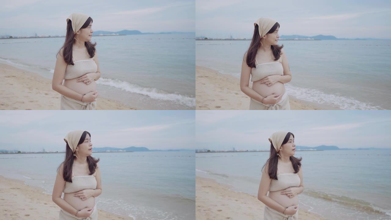 站在海滩上的孕妇。