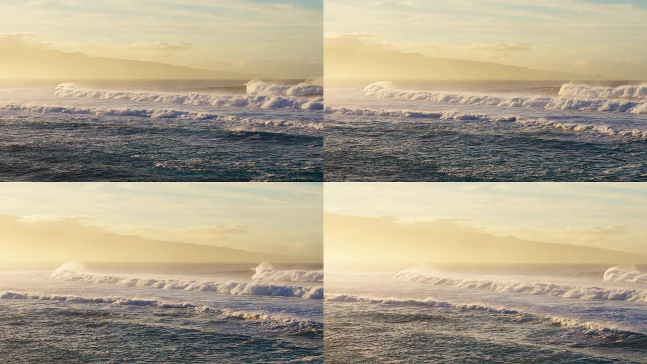 日落时海浪撞击的鸟瞰图