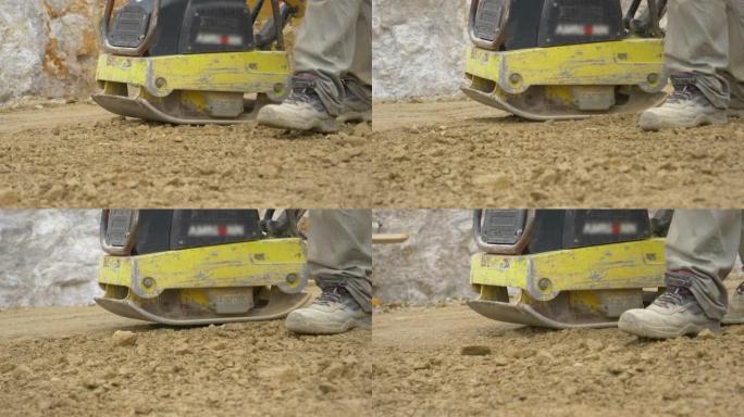 特写: 工人使用找平机为混凝土浇筑准备地面