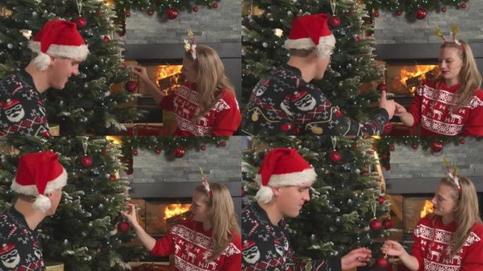 可爱的夫妇穿着节日服装，在燃烧的壁炉旁装饰圣诞树