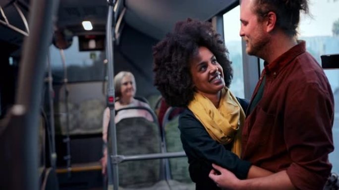 多种族夫妇在公共巴士内互相拥抱微笑