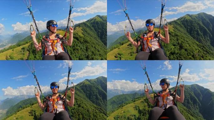POV女人在飞行滑翔伞时欣赏群山美景